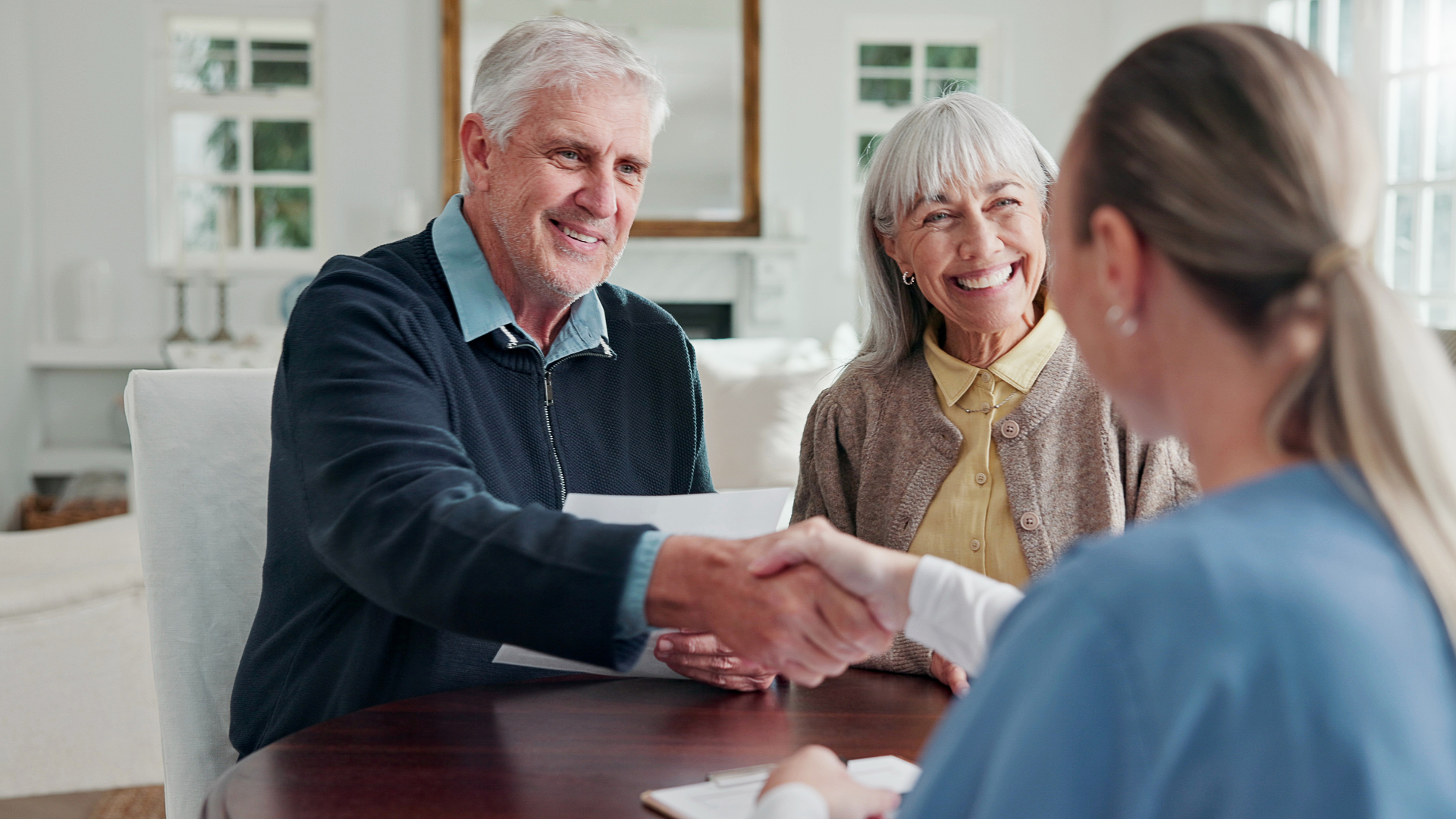 healthcare professional meeting with a client and shaking hands
