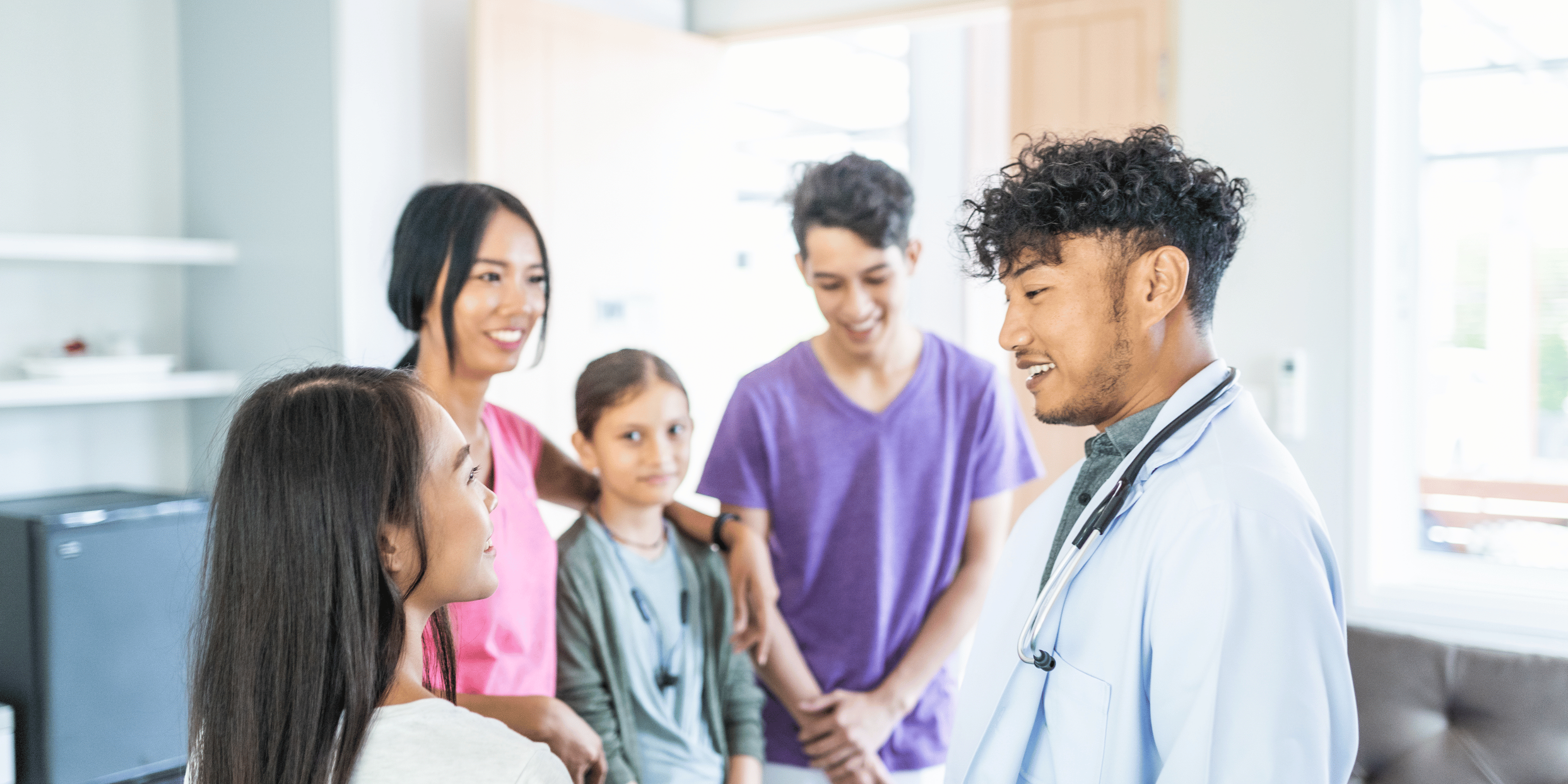 nurse speaking to the family of a patient, and offering them reassurance
