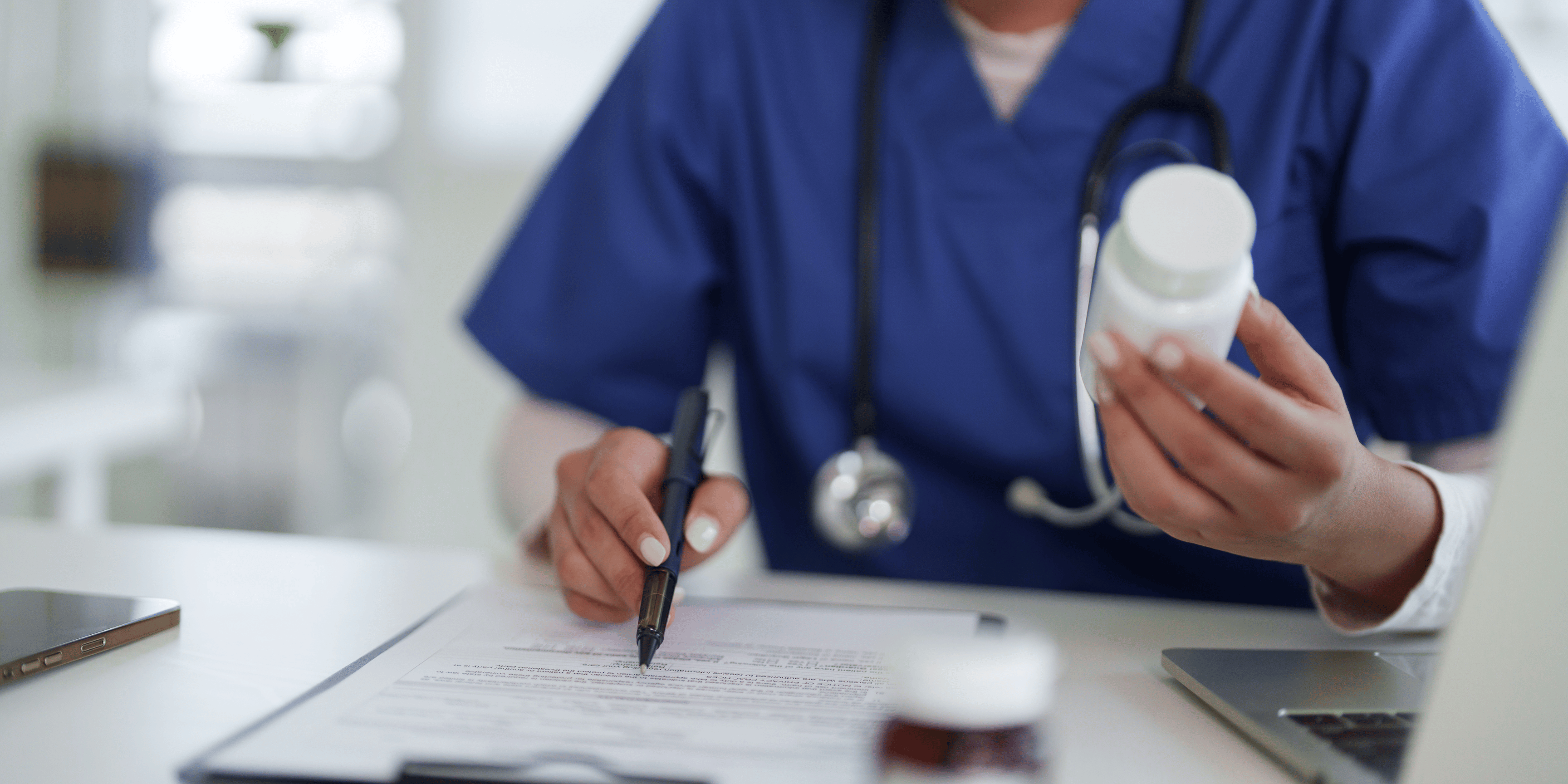 Nurse holding pills while taking notes