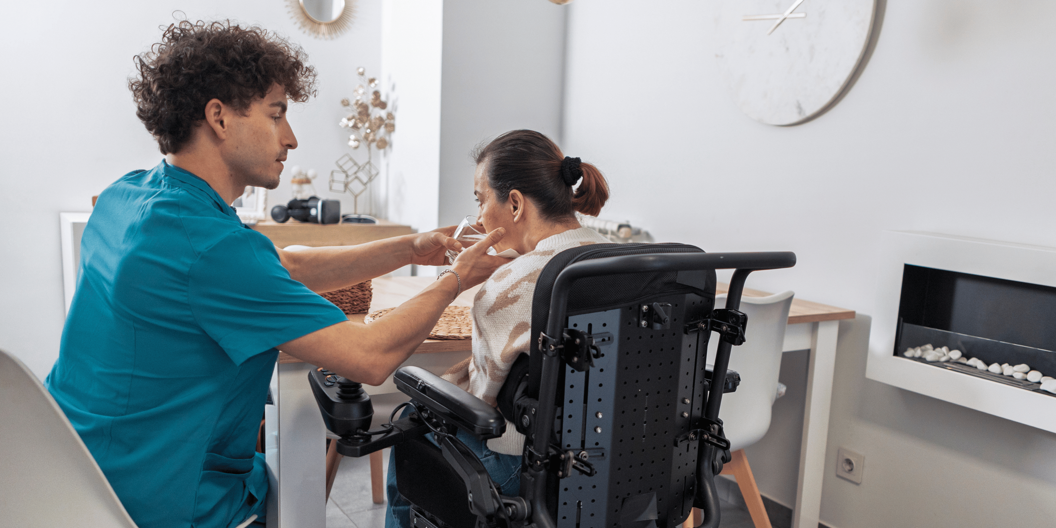 Carer assisting patient to drink water