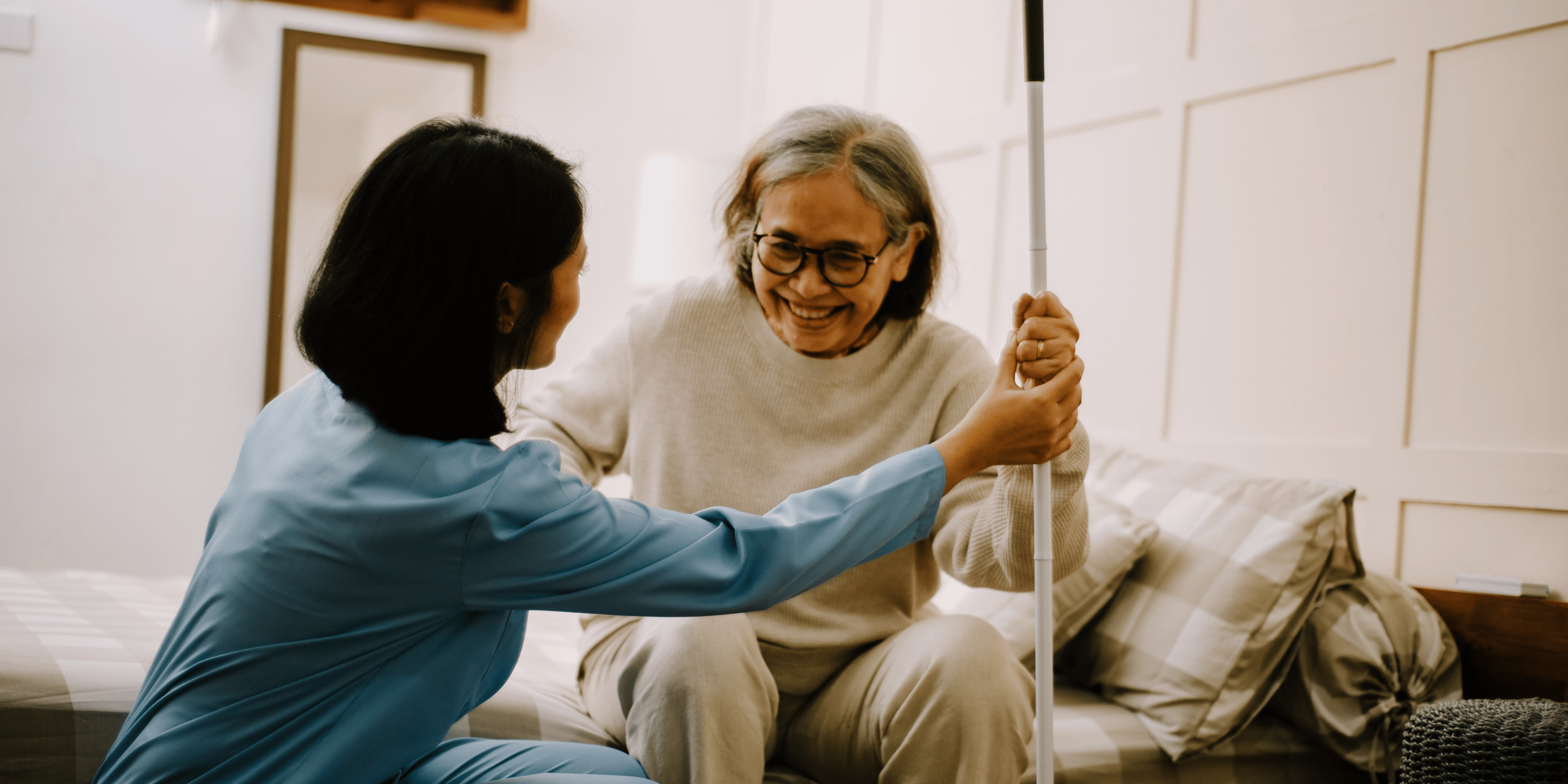 Health professional helping patient up from their seat