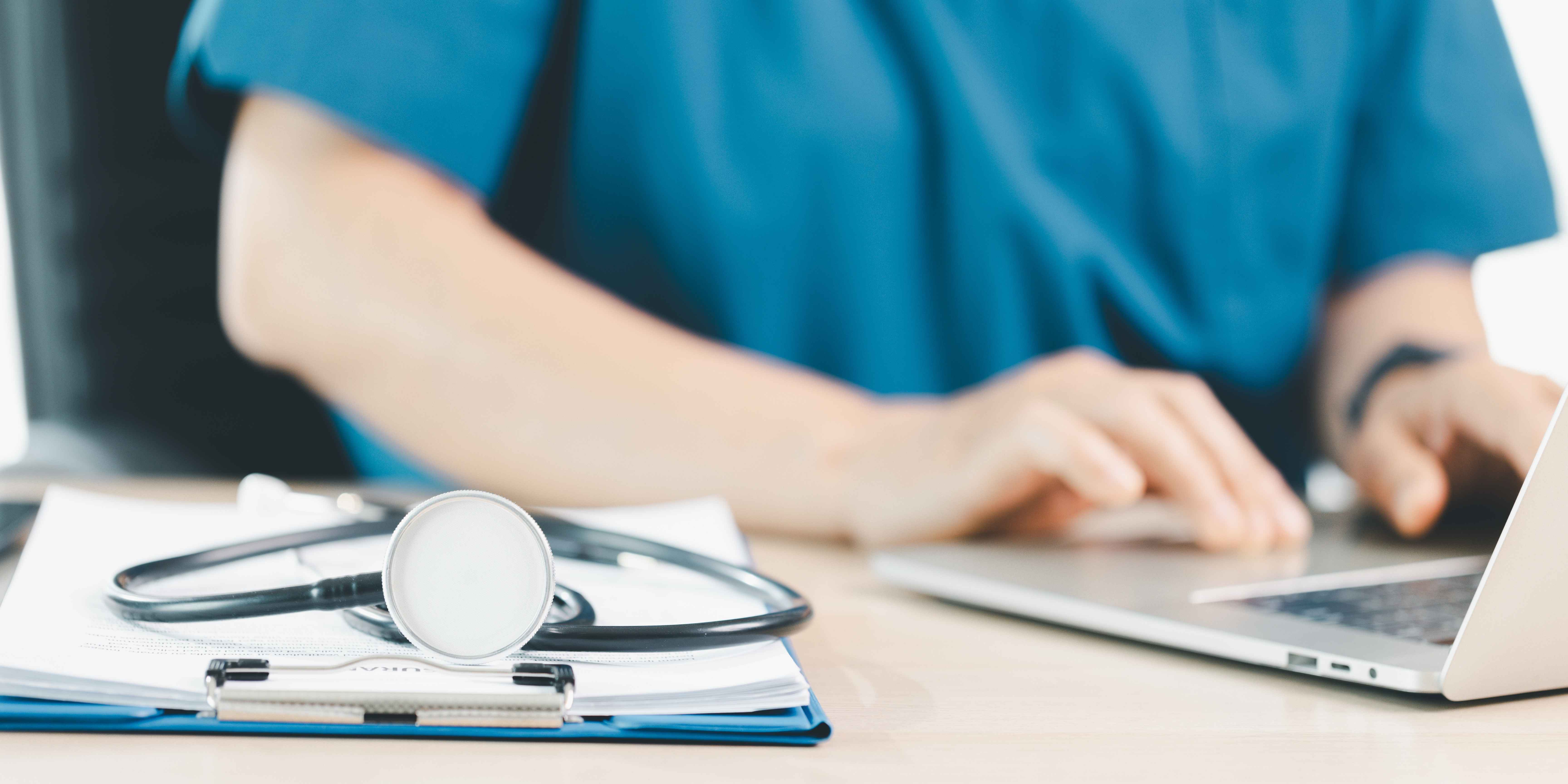 Nurse doing paperwork, and going through compliance documentation