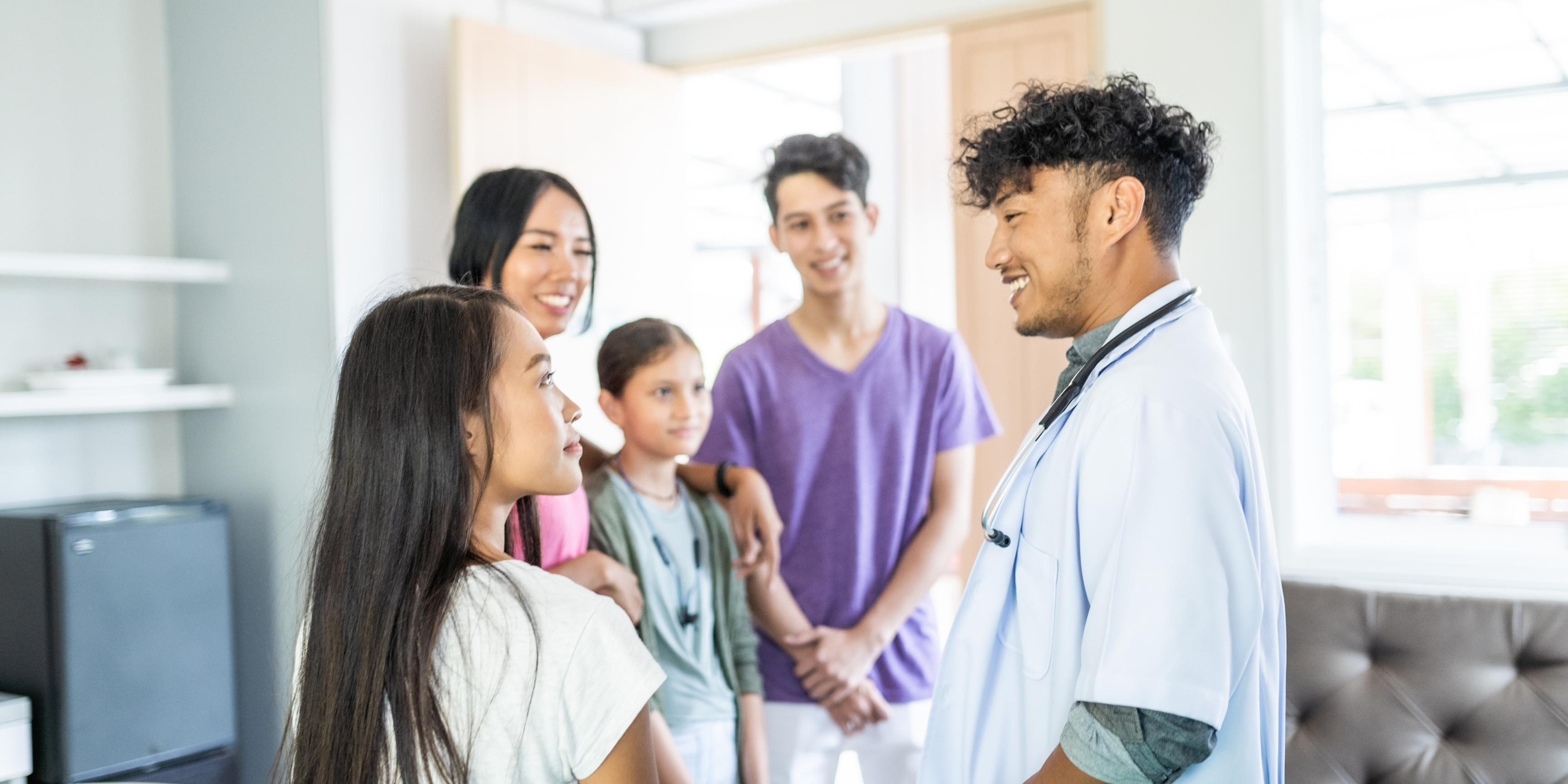 nurse speaking to the family of a patient, and offering them reassurance